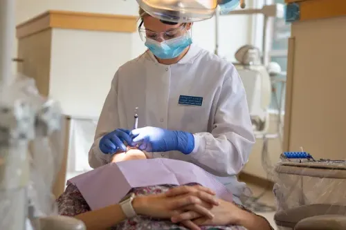 A dental hygiene student cleaning a patients teeth